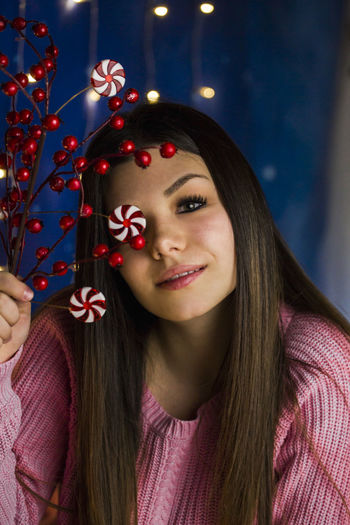 Close-up of young woman with christmas tree