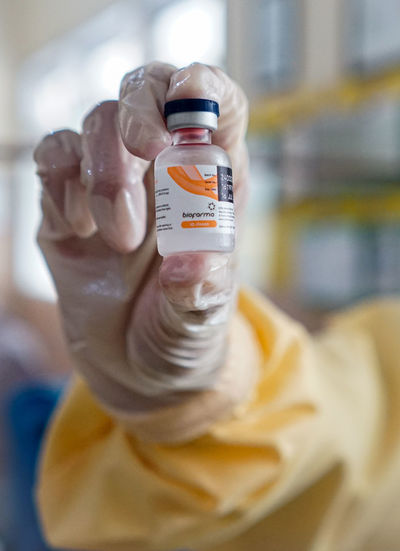 Close-up of hand holding bottle