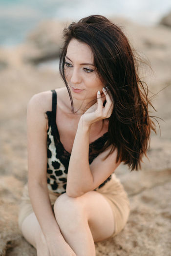 Portrait of woman sitting on beach