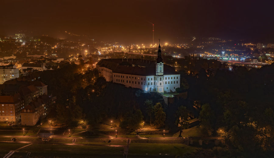 Illuminated buildings in city at night