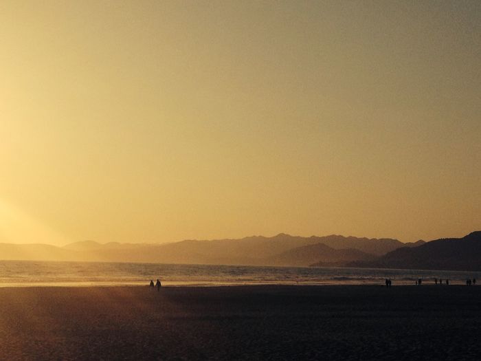 Scenic view of beach against sky during sunset