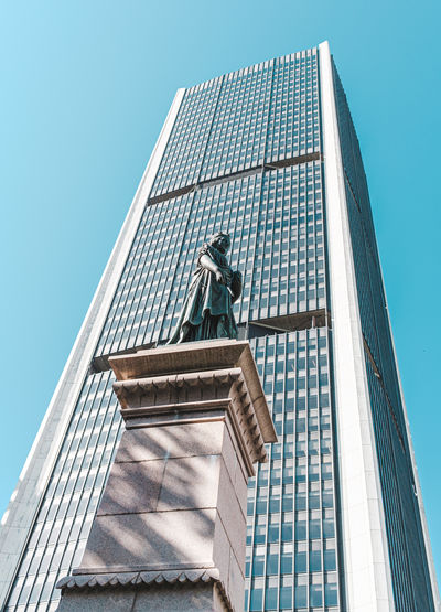 Low angle view of office building against clear sky
