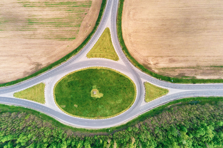 Circle crossroad among fields in countryside, aerial view. transportation infrastructure