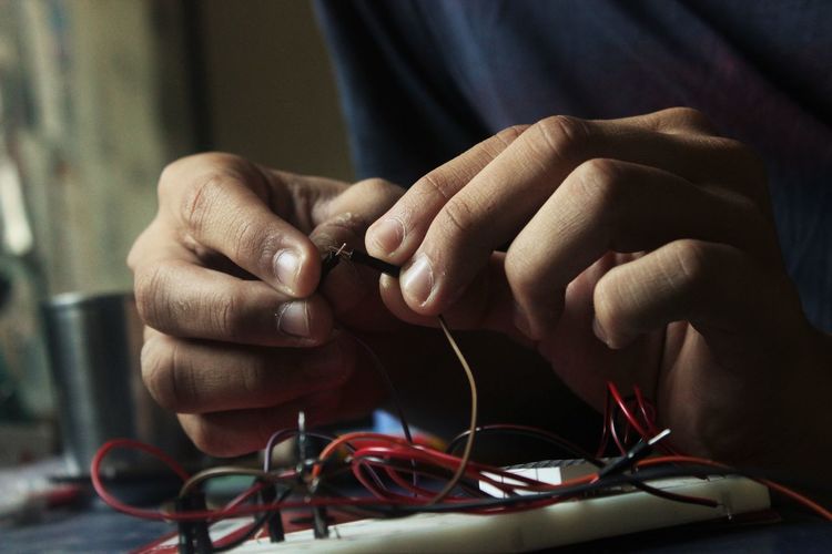 Close-up of man working with electronics