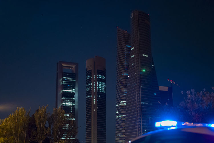 Police car next to madrid's skyscraper