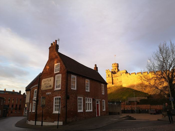 Exterior of tower and wall of lincoln castle in morning sunlight