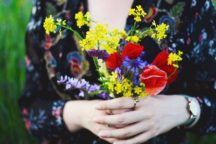 Close-up of person holding bouquet