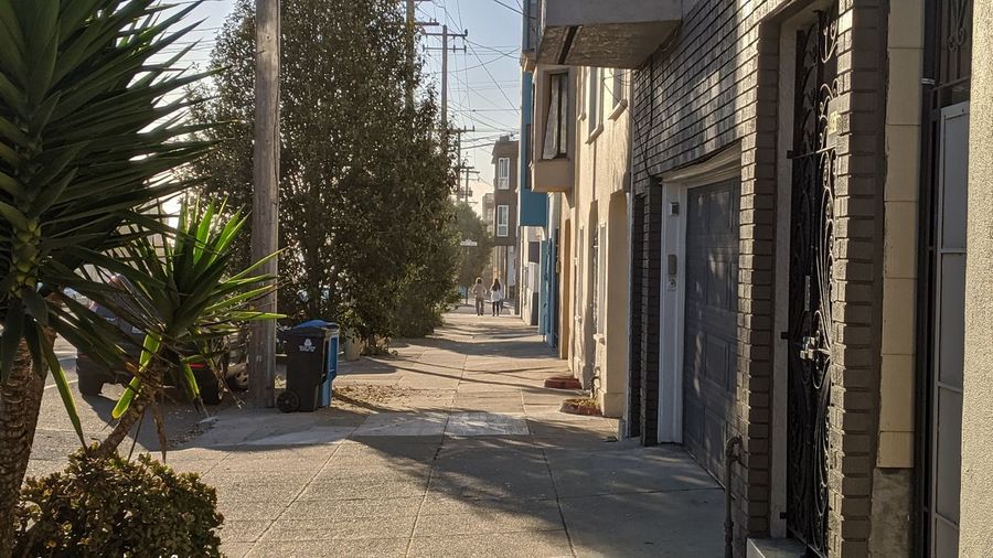 Empty alley amidst buildings in city