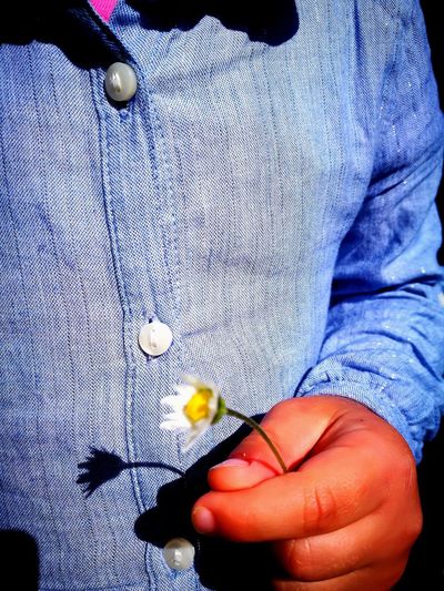 Midsection of man holding flower