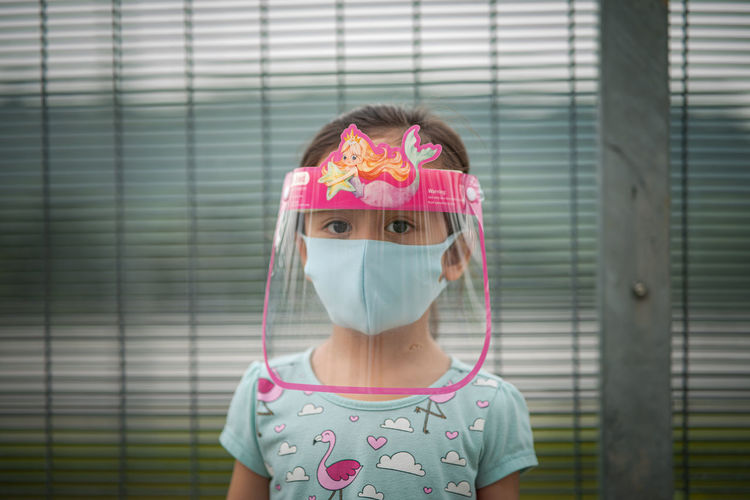 A child wearing face shield in outdoor during coronavirus epidemic. new normal lifestyle.