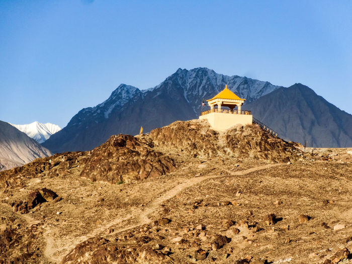 Scenic view of mountains and hindu temple against sky