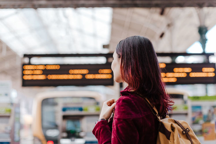 Woman standing at railroad station
