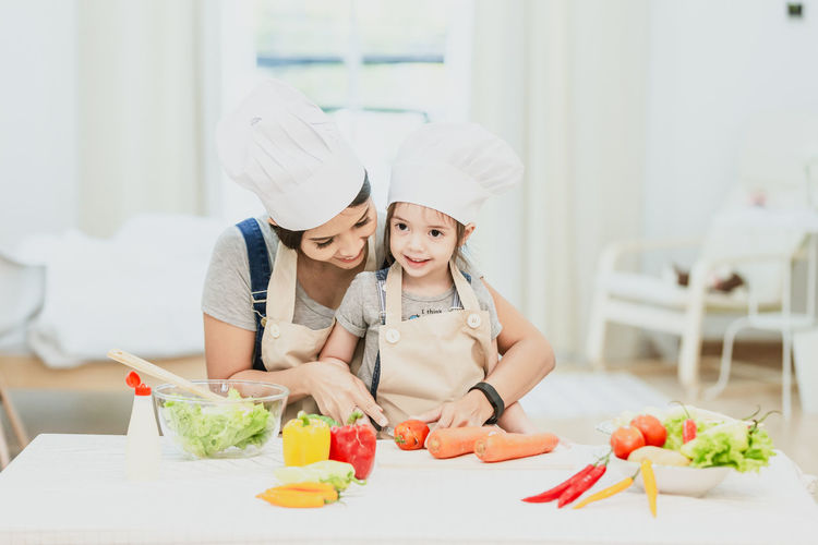 Midsection of woman having food in kitchen