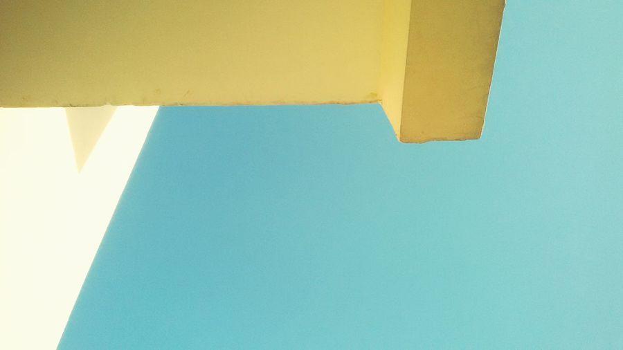 Low angle view of paper against clear blue sky