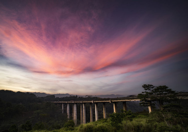 Arch bridge against sky during sunset