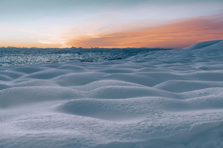 Scenic view of land against sky during sunset