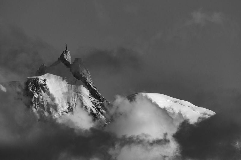 Low angle view of snowcapped mountain against sky