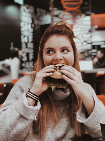Portrait of young woman eating food