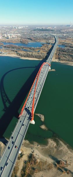 Aerial view of bridge over cityscape against sky