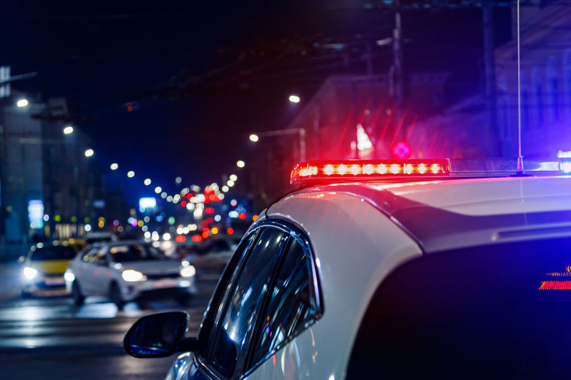 Police car lights in night city with selective focus and bokeh