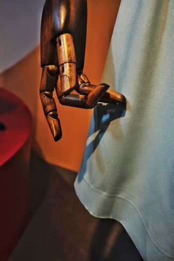 Close up of wooden hand by fabric at store