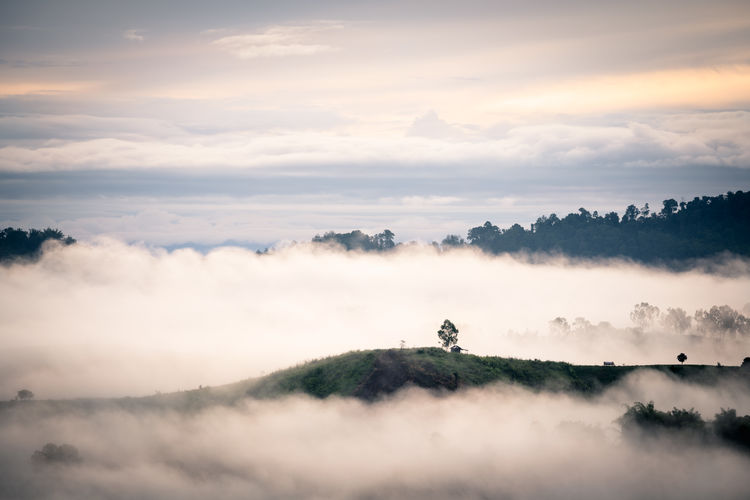 White mist with early sunrise over the hill in rainy season of thailand