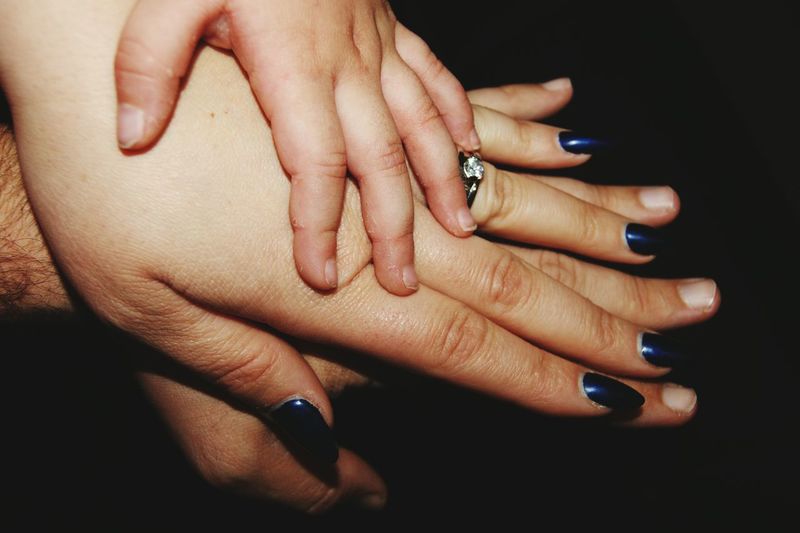 Cropped image of hand holding hands over white background