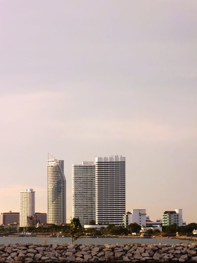 Modern buildings in city against clear sky