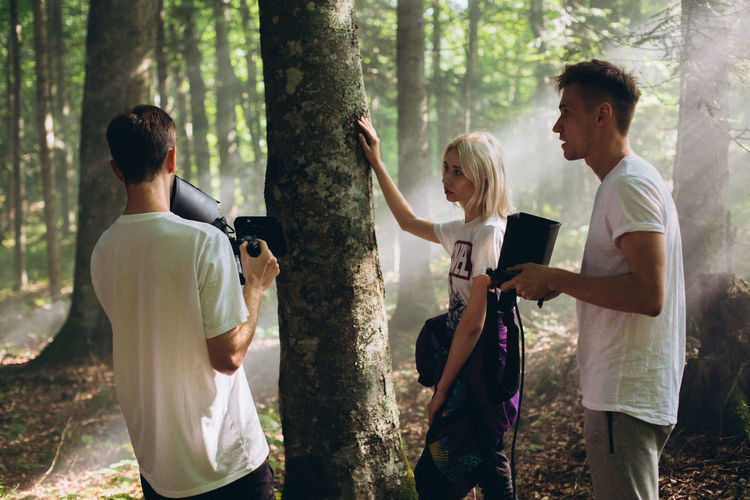 People with camera in the forest