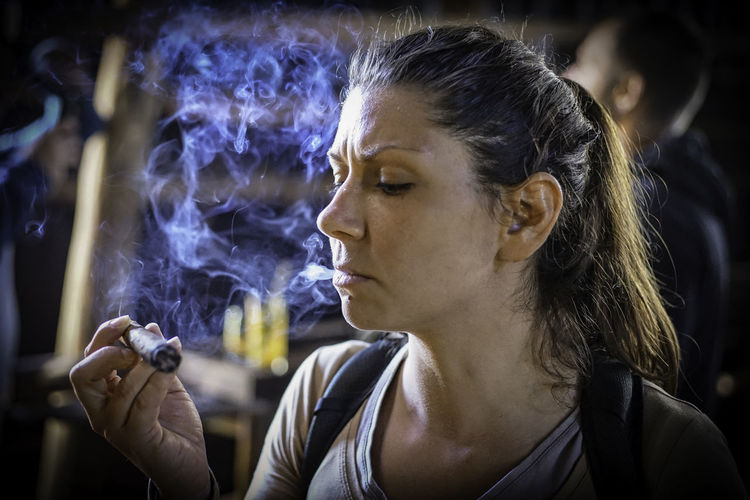 Close-up of woman smoking cigar