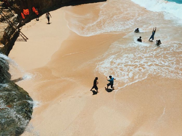 People playing football at beach