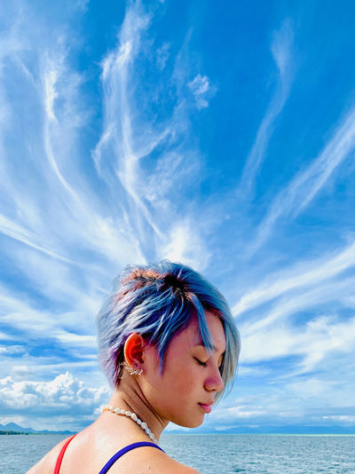 Portrait of woman against sea against sky
