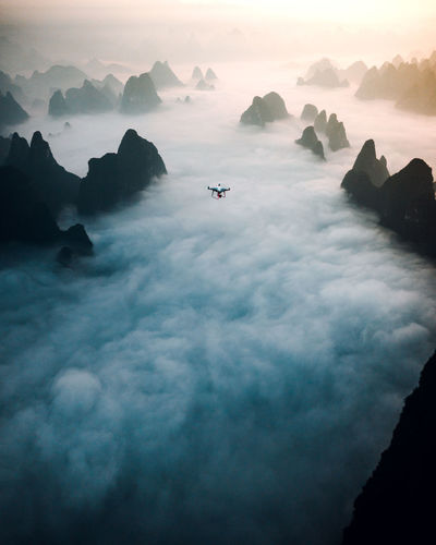 Aerial view of drone flying over clouds