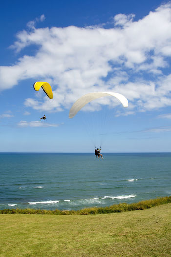 Paragliders flying over the sea in the city of torres in the state of rio grande do sul