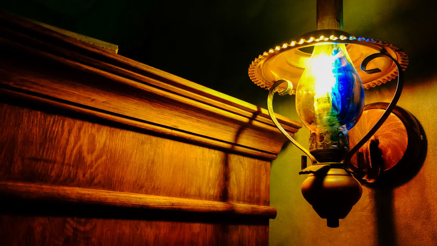 Low angle view of illuminated light bulbs hanging from ceiling