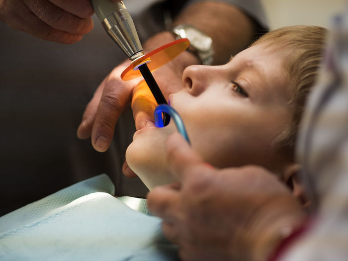 Dentist examining boy in hospital