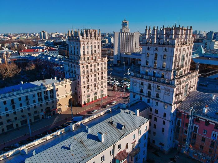 High angle view of buildings against blue sky
