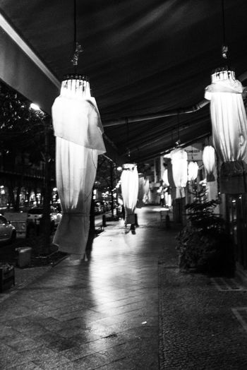 Man hanging in illuminated market at night
