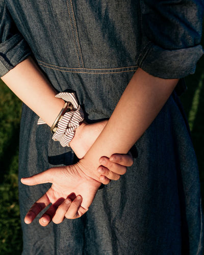 Midsection of woman holding hands
