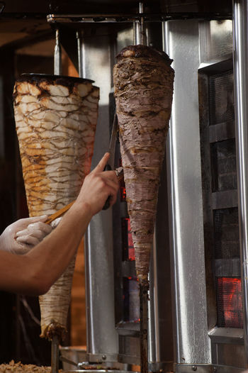 Close-up of man preparing shawarma at shop
