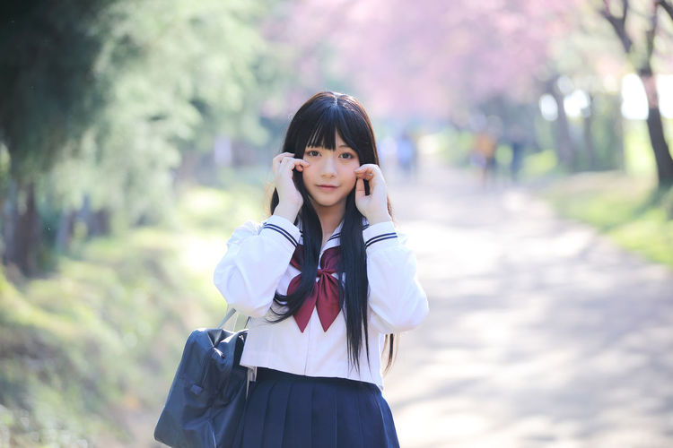 Portrait of young woman standing outdoors