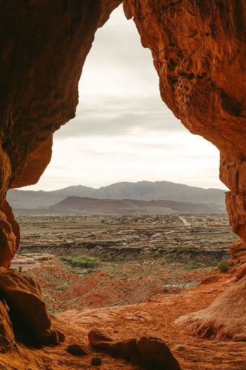 Desert cave entrance overlooking the suburbs of st. george utah