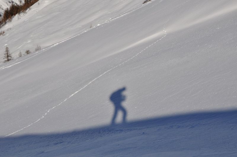 Shadow of person on snowcapped mountain
