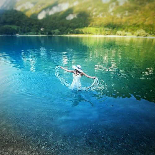 Bird flying over lake