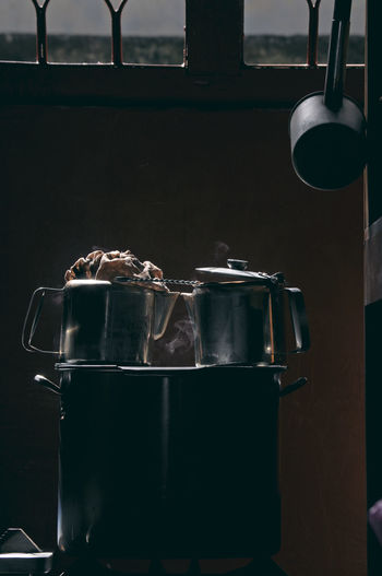 Low key phot of coffee and tea maker using traditional pots and kettles