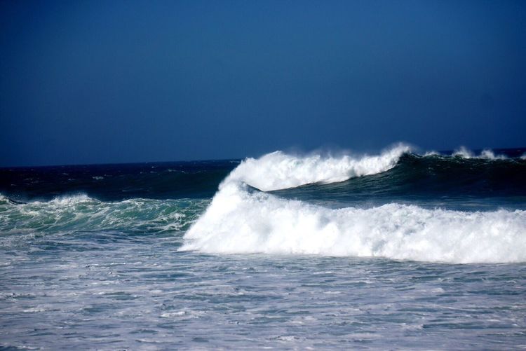 Scenic view of sea against clear blue sky