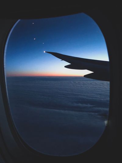 Airplane flying in sky seen through window