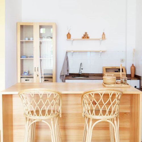 The kitchen dining table and chairs made of wood with rattan look natural and beautiful clean.