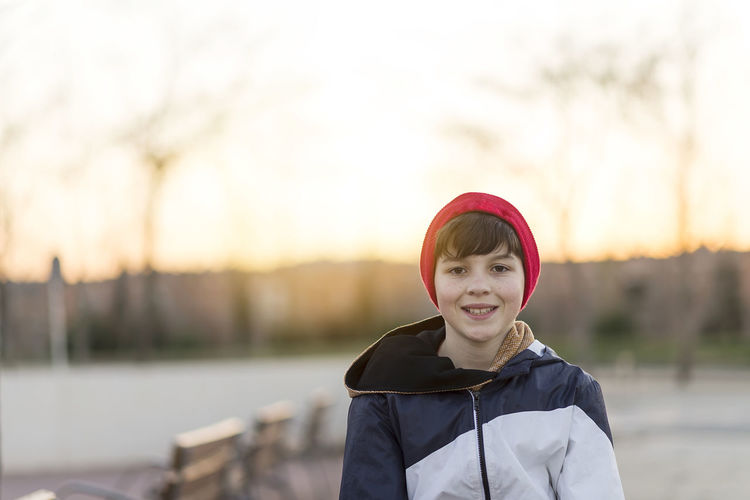 Portrait of boy against sky during sunset