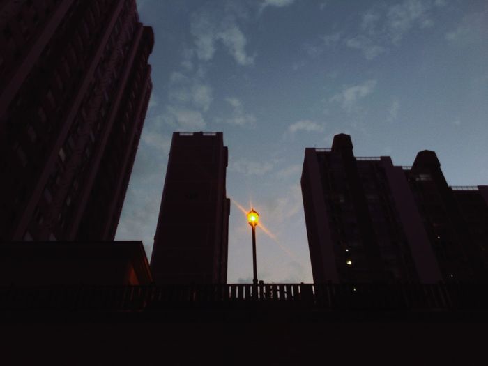 Silhouette of buildings against sky at dusk